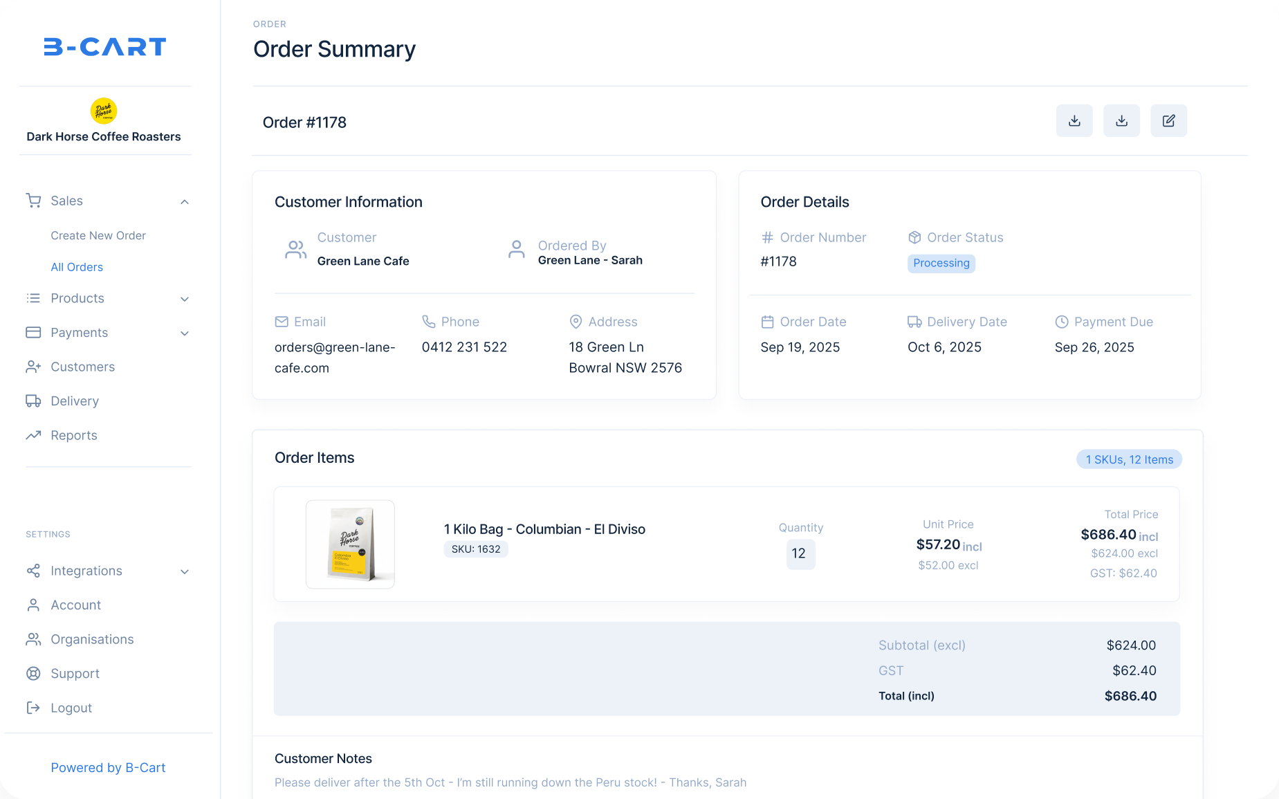 Smiling shop owner holding coffee beans